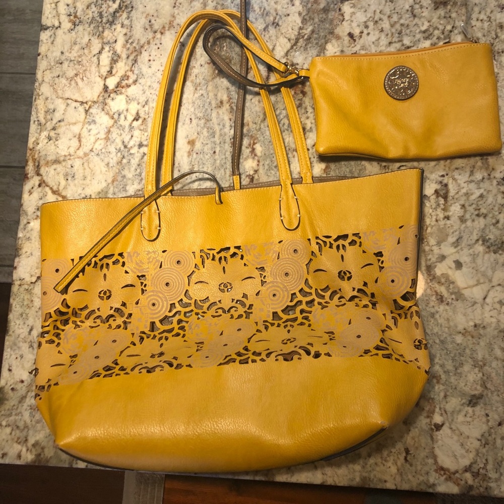 Yellow laser cut tote with matching makeup pouch.
